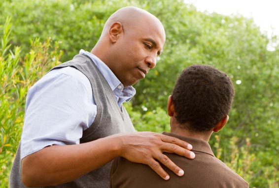 Man providing guidance to son as example of talking to your kids about ebola