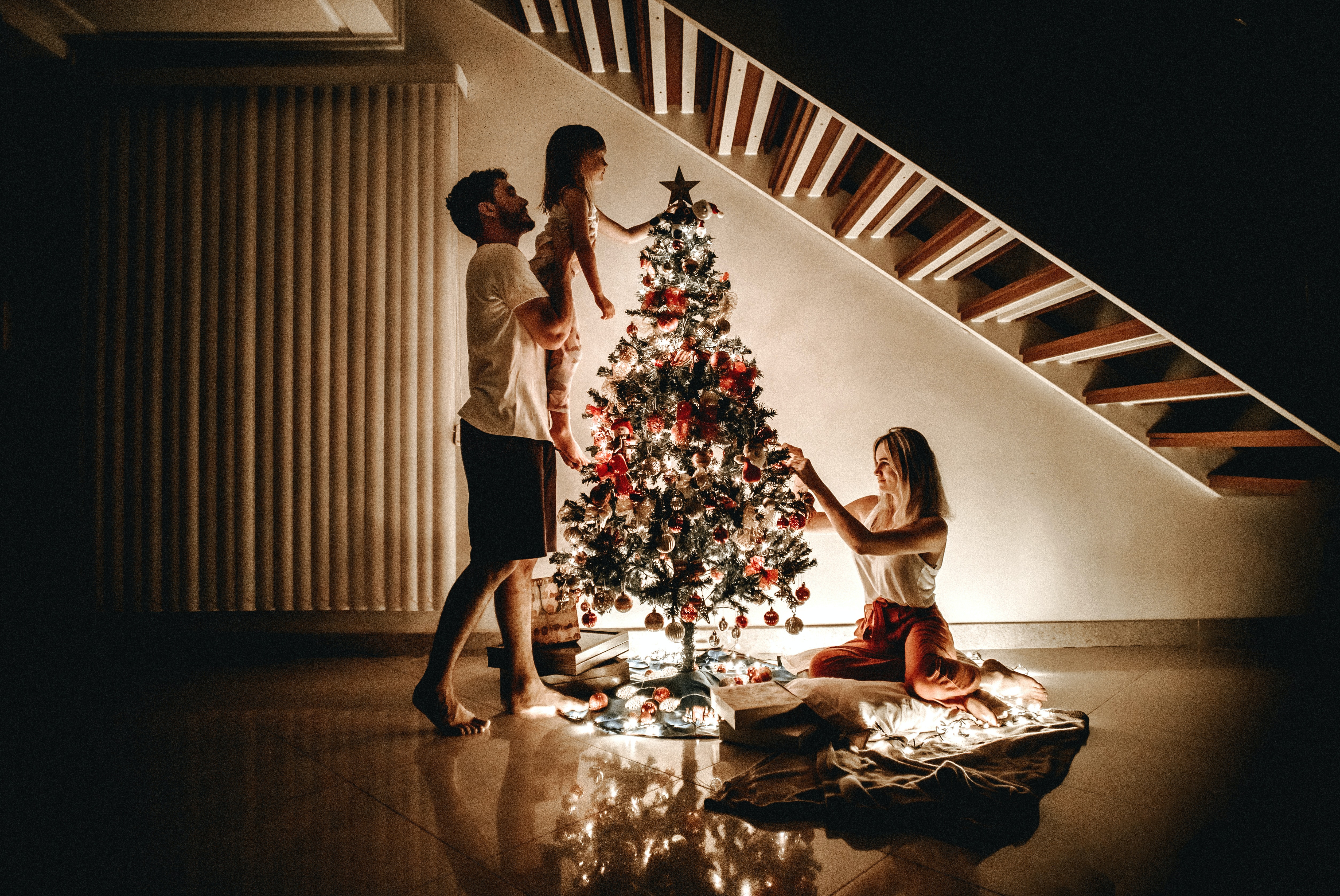 Decorating a holiday tree to representing decorating earlier to help reduce holiday stress.